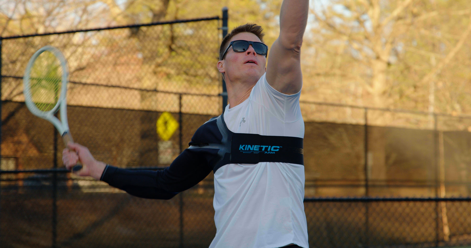 tennis player serving on court wearing K2 sleeve 